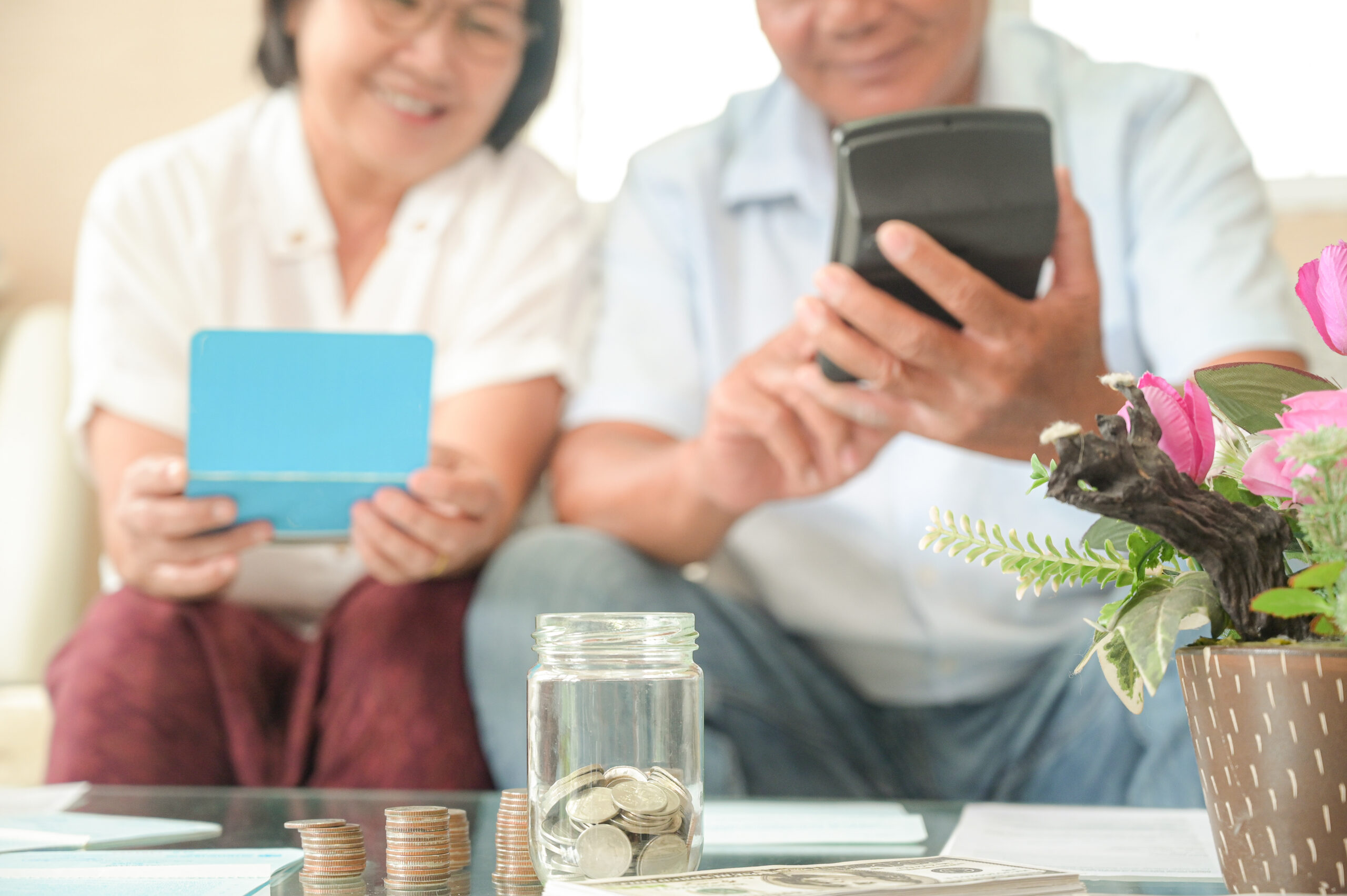 Old asian women and men sit on the sofa, they make financial pla Pension Bonus