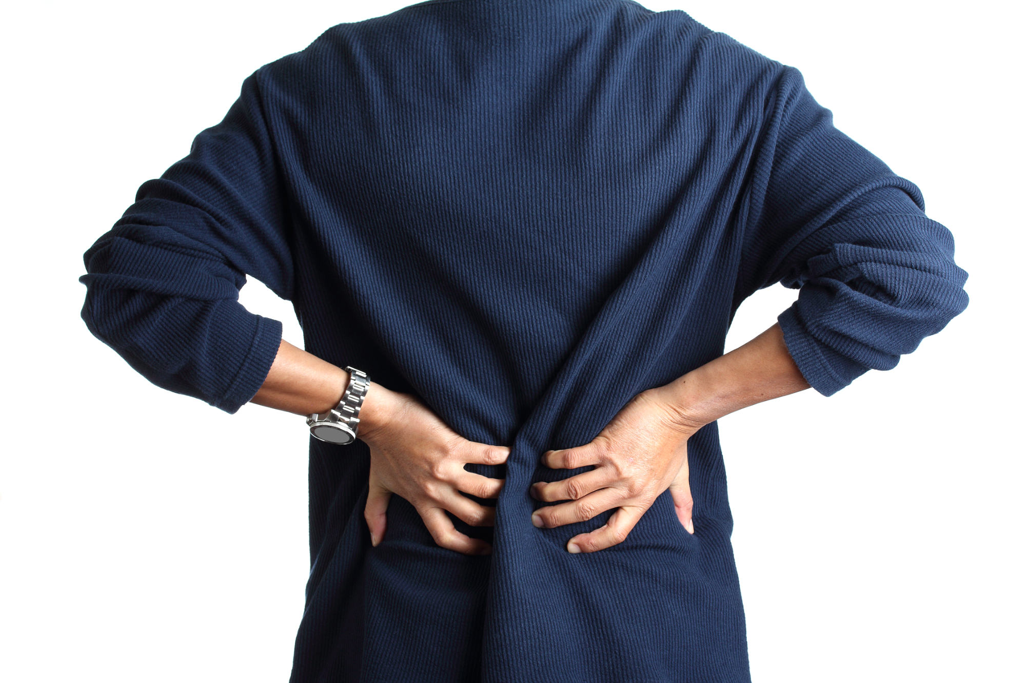 A person wearing a navy blue long-sleeve shirt holds their lower back with both hands, appearing to be in discomfort or pain, possibly seeking back pain compensation. The background is white. A person wearing a navy blue long-sleeve shirt holds their lower back with both hands, appearing to be in discomfort or pain, possibly seeking back pain compensation. The background is white.