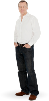 A man stands with his hands in his pockets, wearing a white shirt, dark jeans, and brown shoes. He is smiling and facing forward. A man stands with his hands in his pockets, wearing a white shirt, dark jeans, and brown shoes. He is smiling and facing forward.