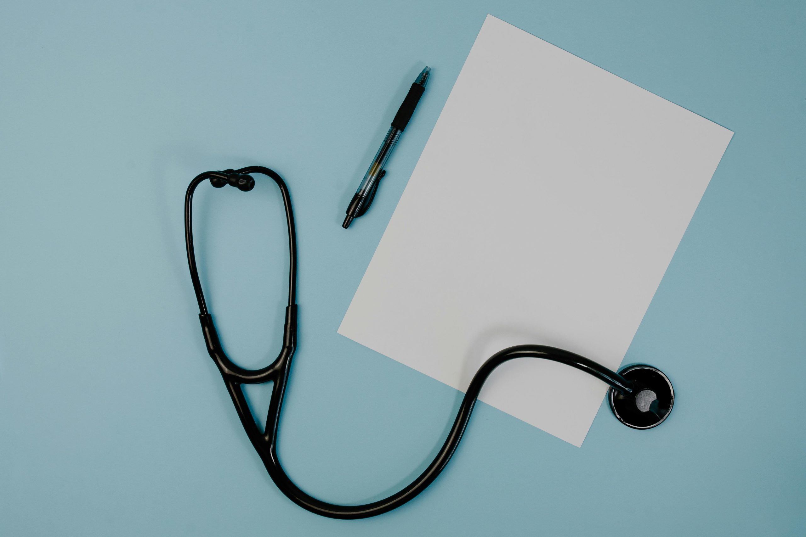 Black Stethoscope Near the Blank Paper Black Stethoscope Near the Blank Paper